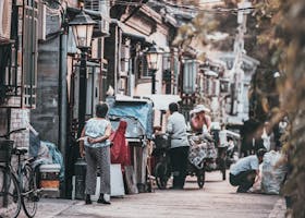 Home A glimpse into the vibrant street life of a traditional hutong in Beijing, China, showcasing daily interactions.